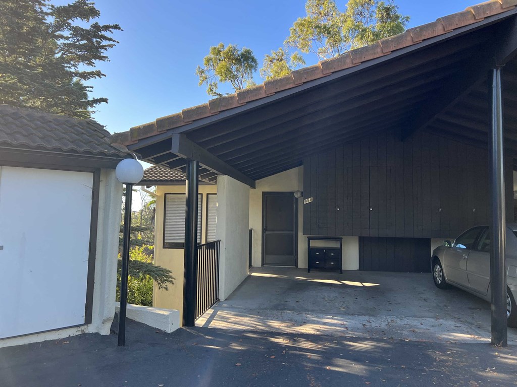a garage with a car parked in front of a house