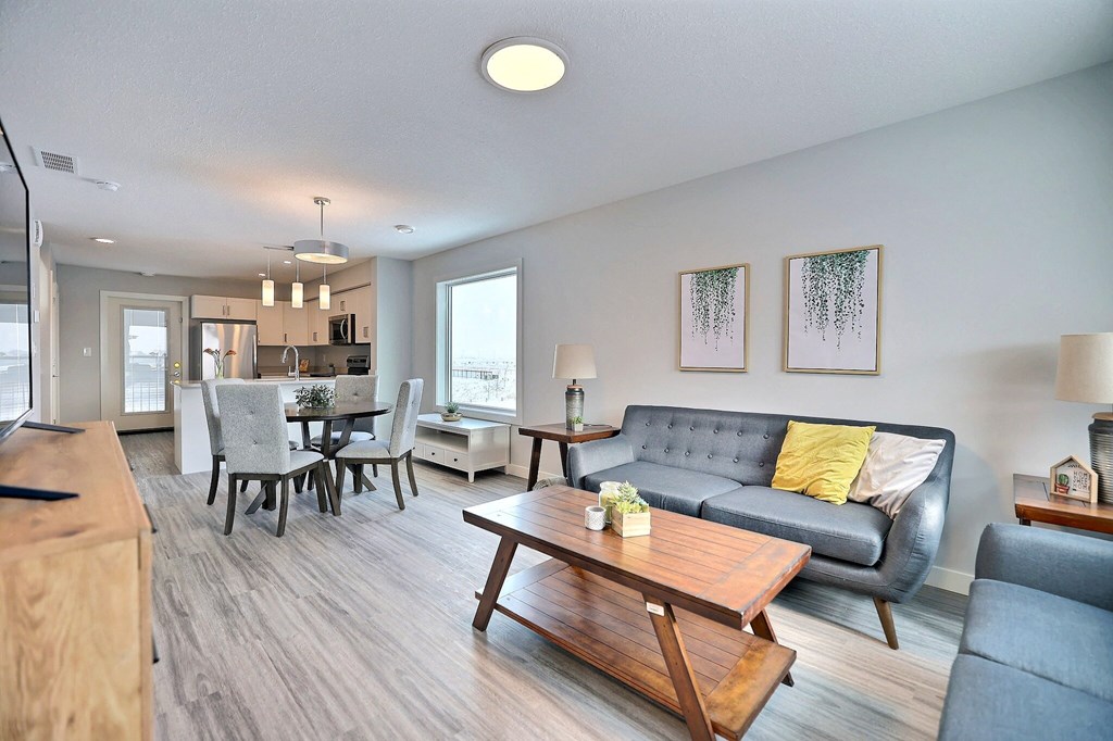 a living room and dining room with a couch and a table