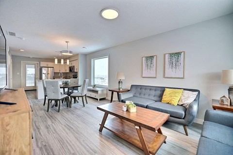 a living room and dining room with a couch and a table