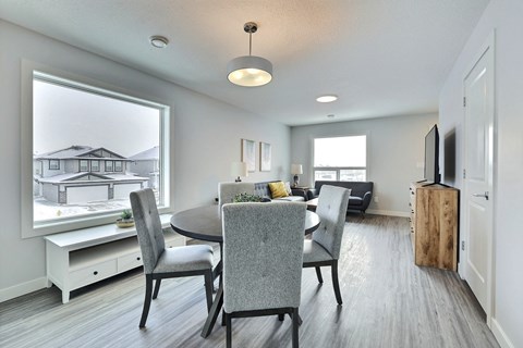 a dining room and living room with a table and chairs