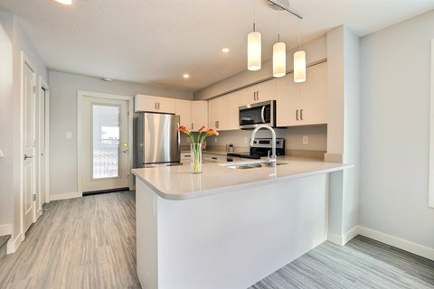 a kitchen with white cabinets and a large counter top