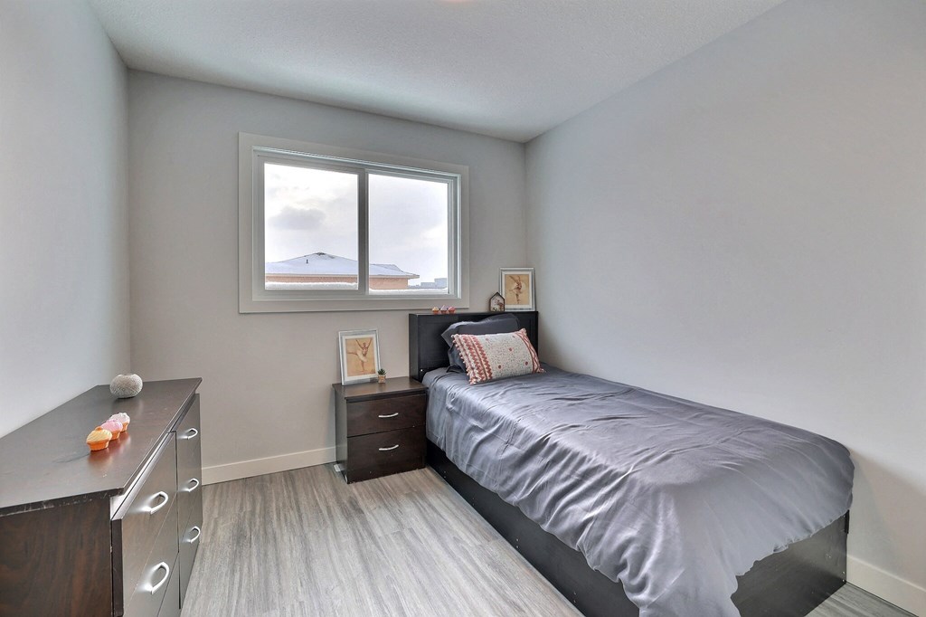 a small bedroom with a bed and a window