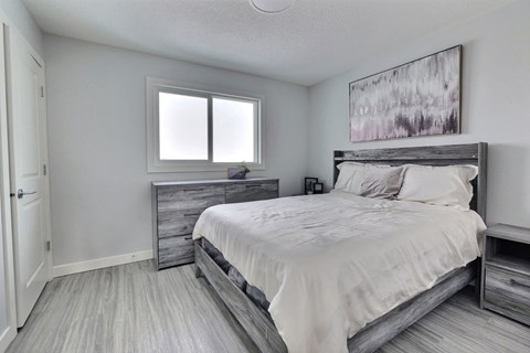 an image of a bedroom with a bed and a window