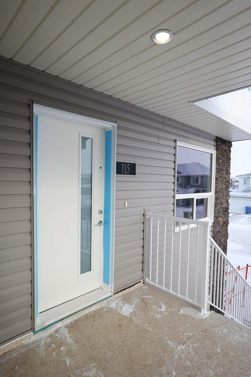 the front door of a home with a glass window and a white door with a