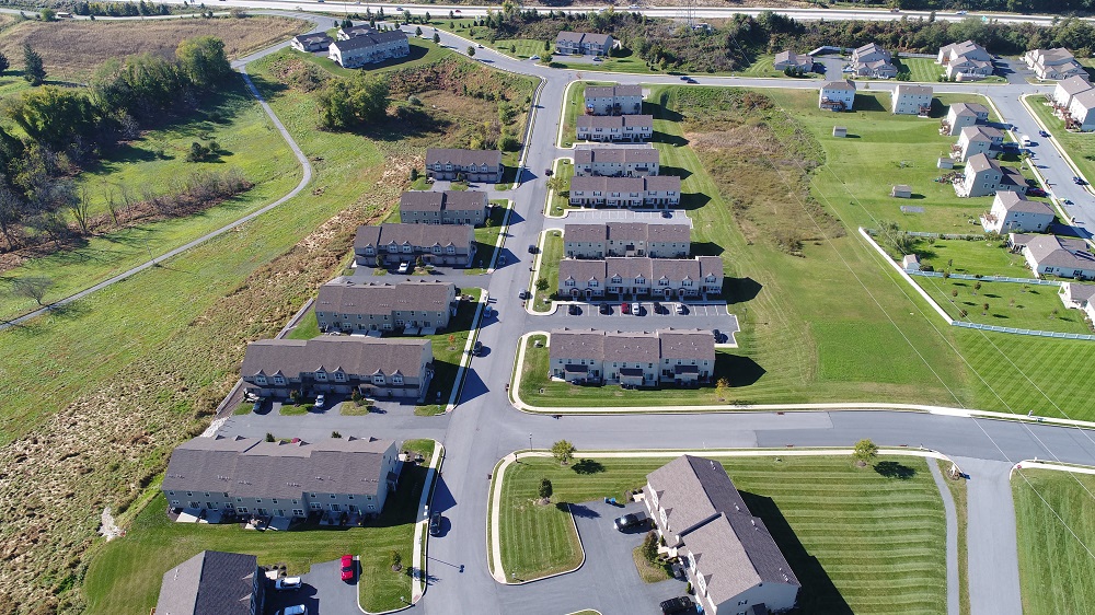 an aerial view of a group of houses in a suburban neighborhood