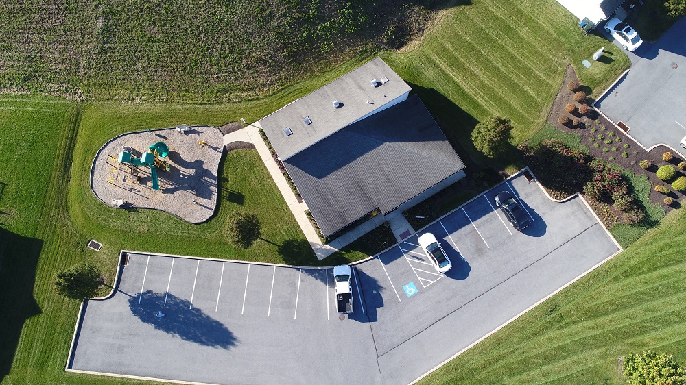 an aerial view of a tennis court and a park