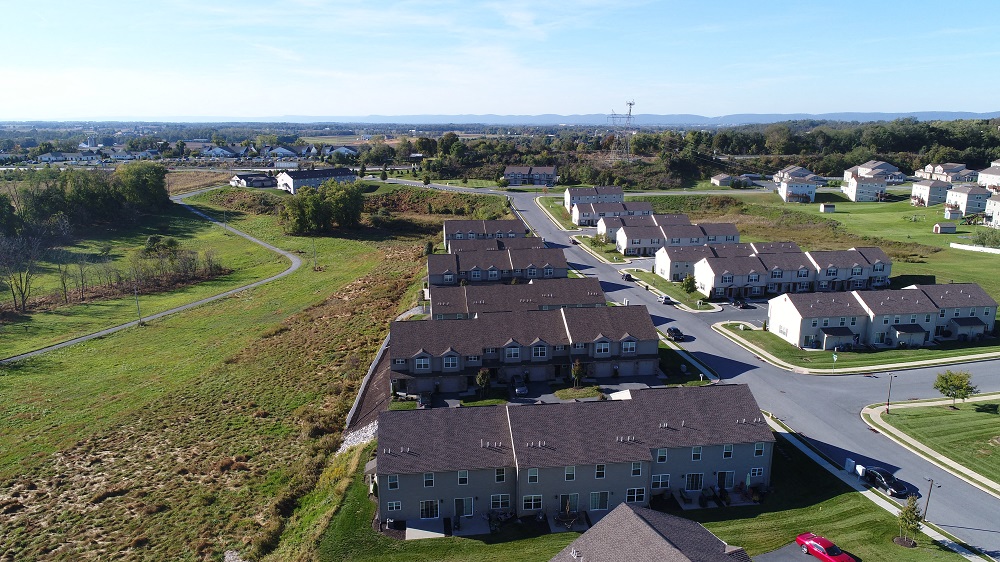 a group of houses sitting next to a road