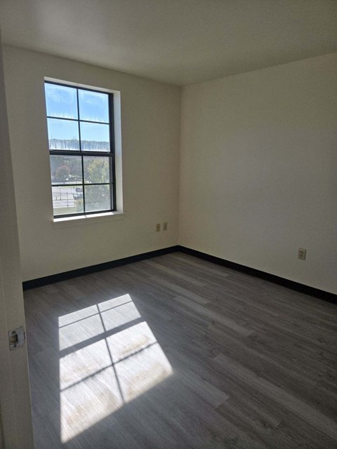 the living room of an empty house with a window