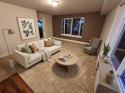 Living room with a sofa, armchair, coffee table, accent wall, and a door leading out to the balcony.