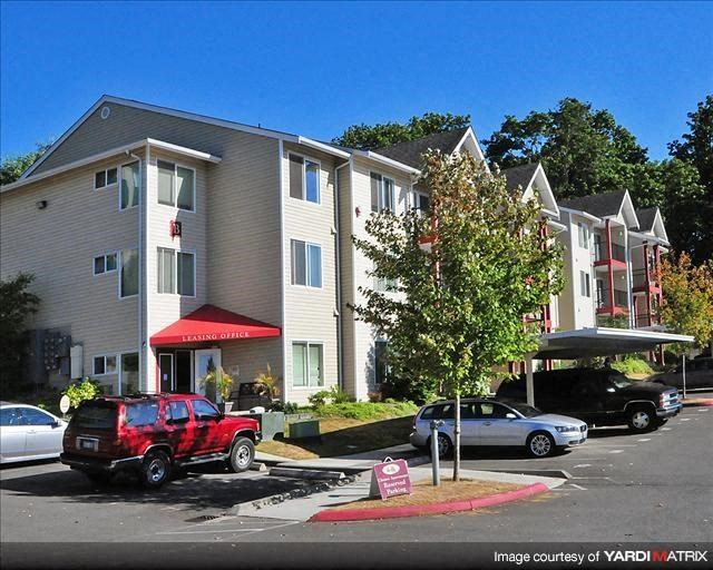 a red truck parked in front of an apartment building