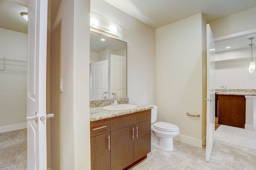 a bathroom with a sink toilet and a mirror