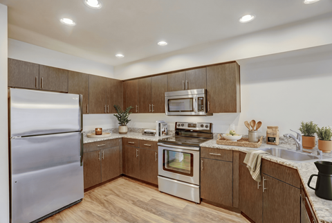 A kitchen with wooden cabinets and stainless steel appliances.