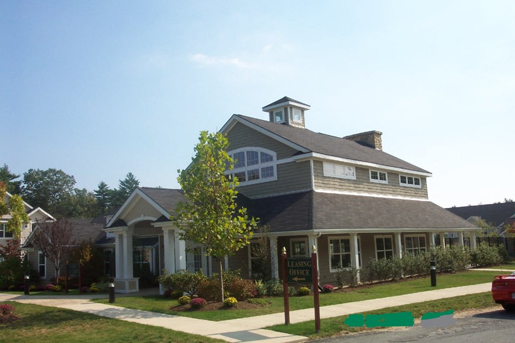 a house with a yard and a sign in front of it