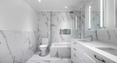 a white bathroom with a toilet and a sink