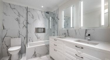 a white bathroom with a toilet and a sink