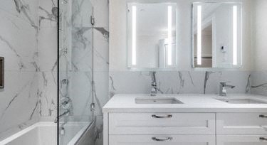 a bathroom with a sink and a mirror and a shower
