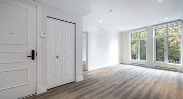 a white room with a door and a window