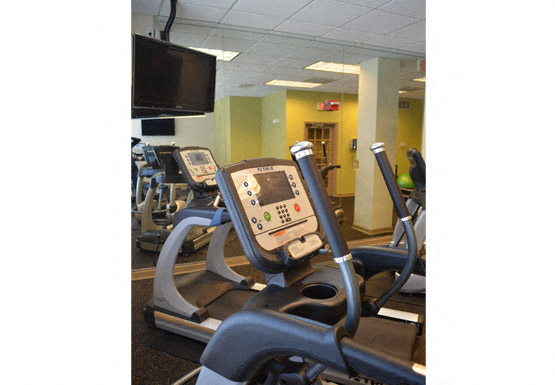 Fitness center with cardio equipment; flat screen TV