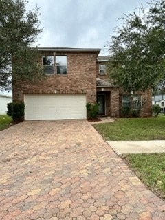 A brick house with a white garage door.