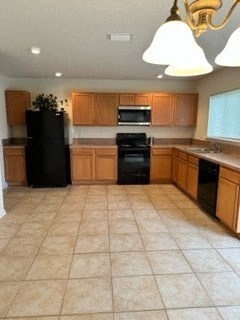 A kitchen with black appliances and wooden cabinets.