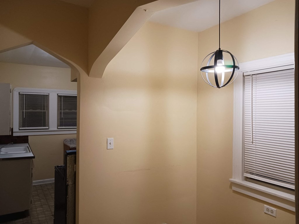 the view from the living room into the kitchen and dining room