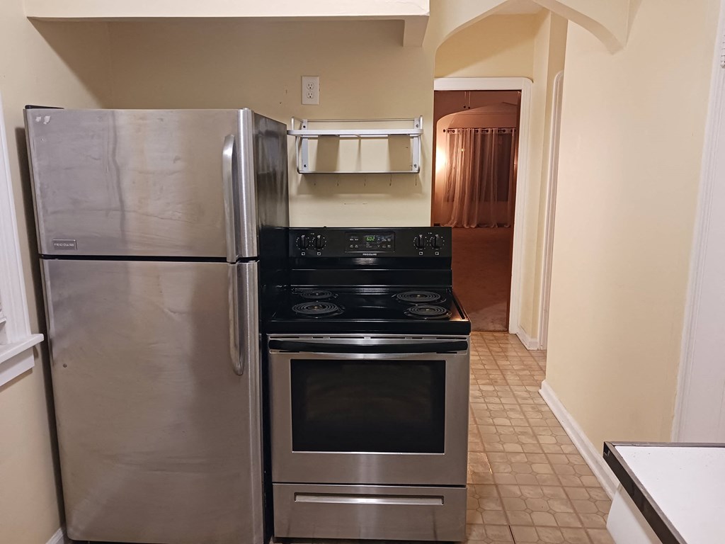 a kitchen with a stove and a refrigerator