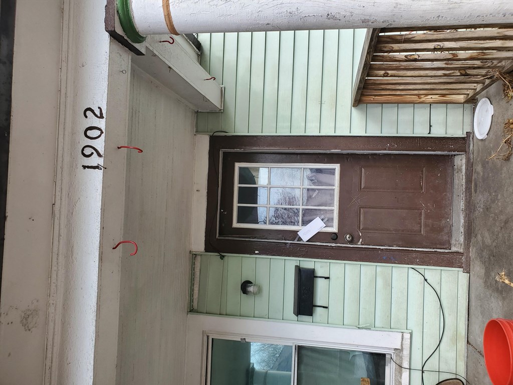 a window on the side of a house with a paper on it