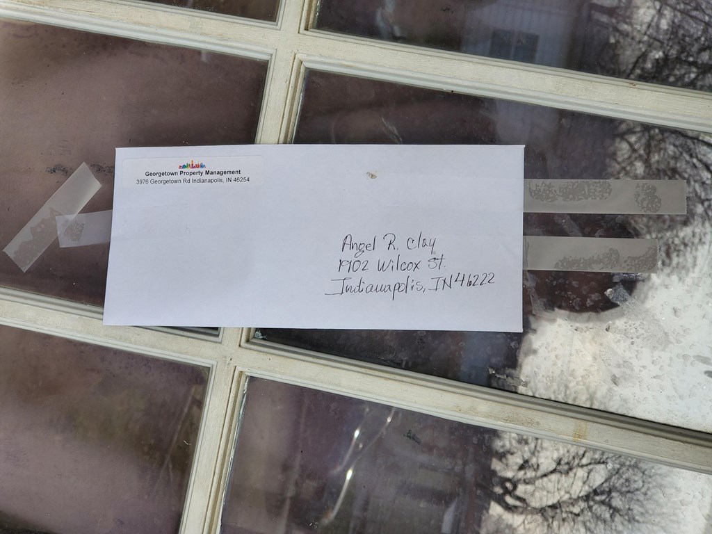 a piece of paper on a glass window with a knife on it