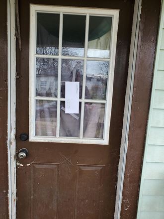 the door of a house with a note in the window