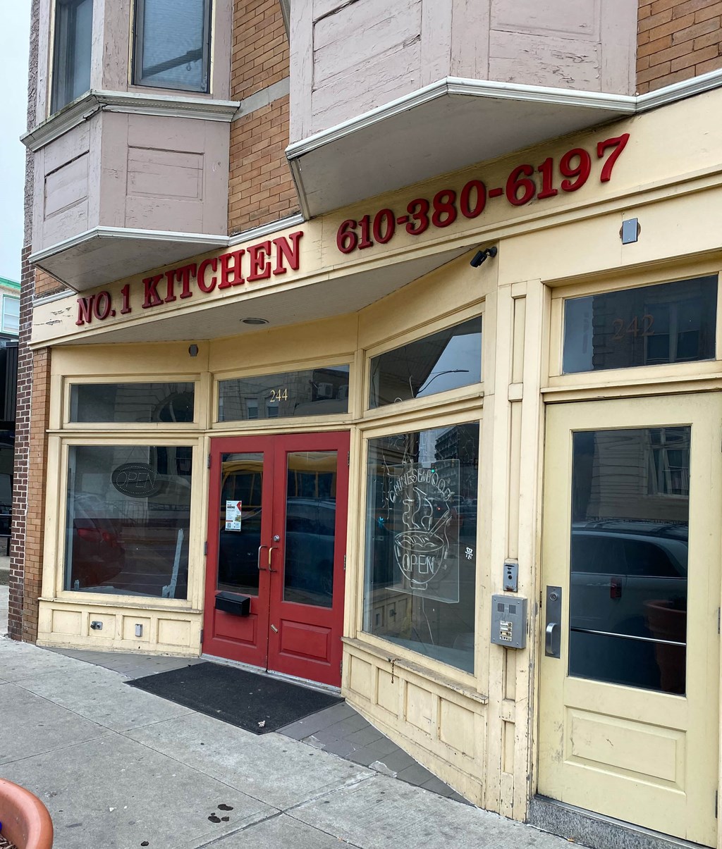 the front of a restaurant with a red door