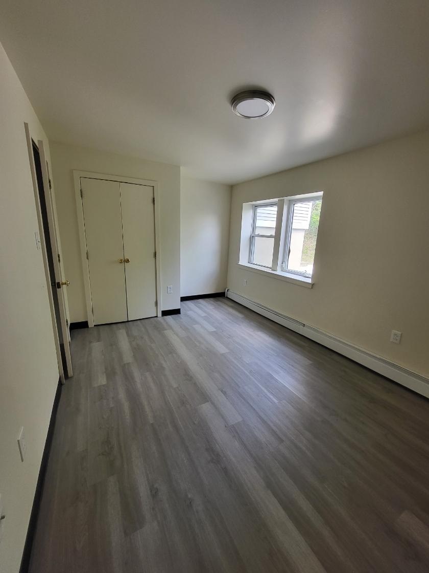 a empty room with a door and a window