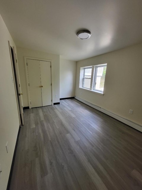 a empty room with a door and a window