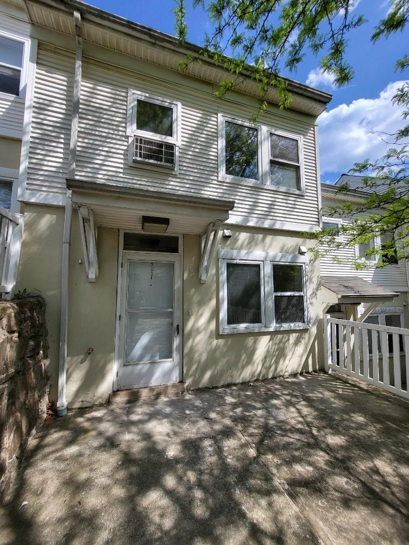 a white house with a gray door and a porch