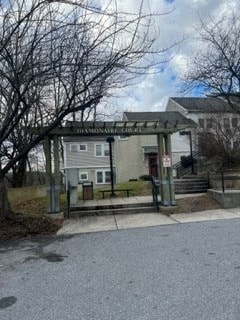 a bus stop with a house in the background