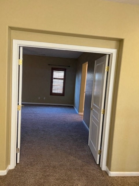 a hallway with a door and a window in it