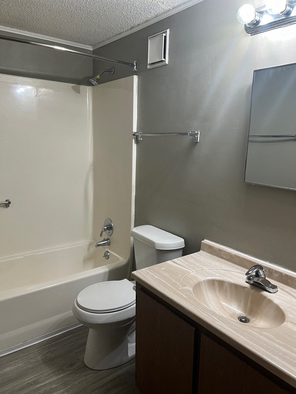 A white toilet sits next to a sink in a bathroom.