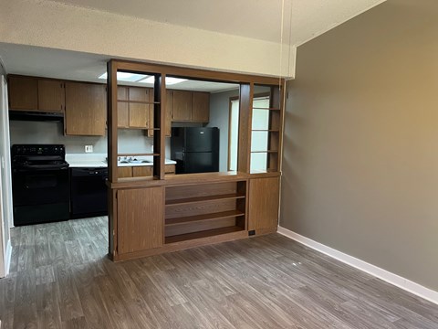 A kitchen with a black fridge and black oven.