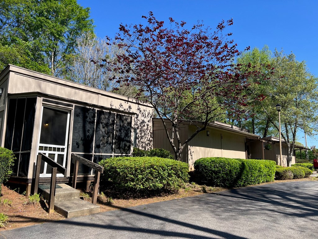 A building with a red tree in front of it.