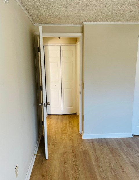 A white door is open to a hallway.