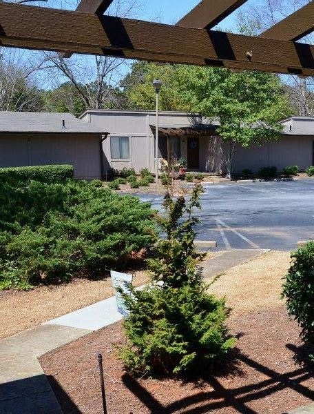 A view of a parking lot with a building in the background.