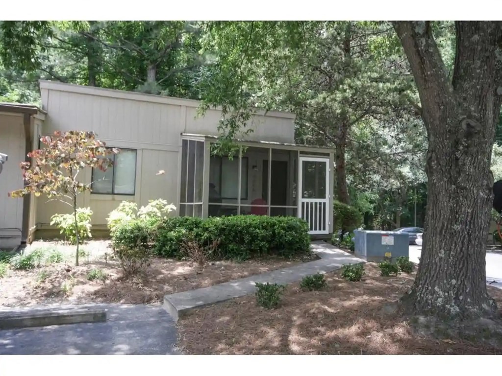 A house with a tree in front of it.