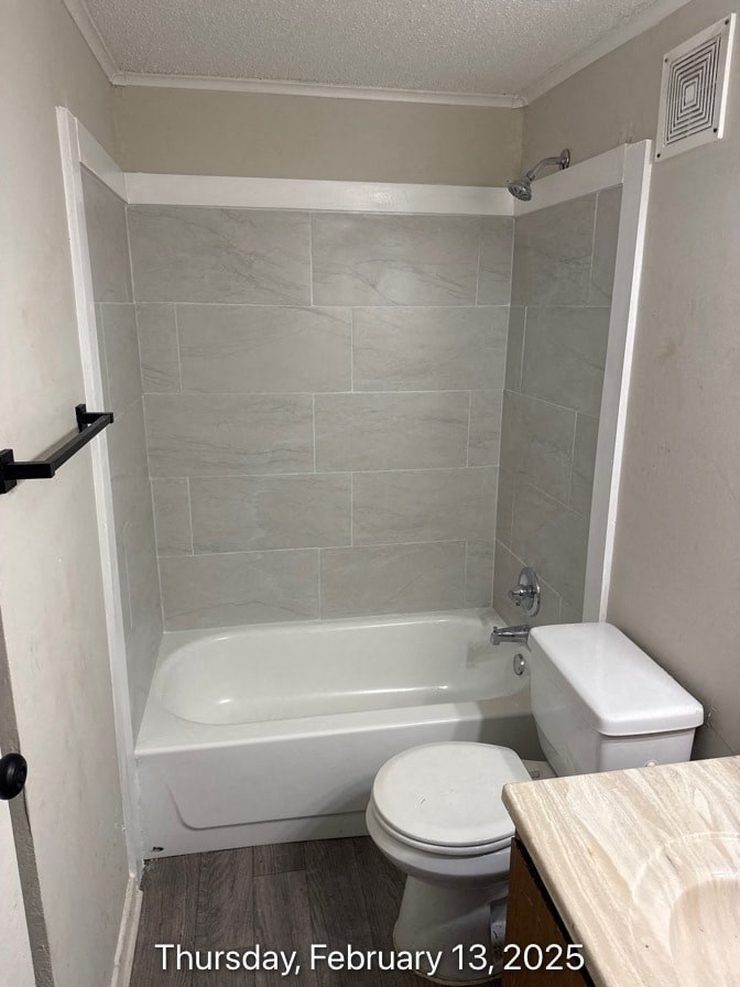 A bathroom with a toilet, tub, and towel rack.