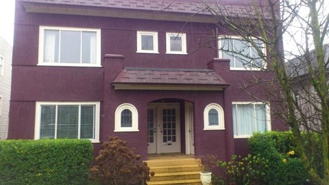 a red house with a front door and steps
