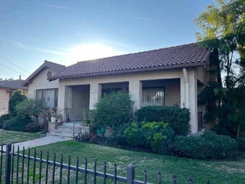 A house with a black fence in front.