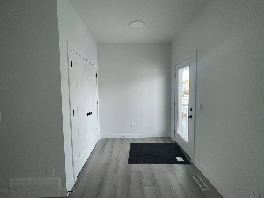 an empty room with white walls and a door