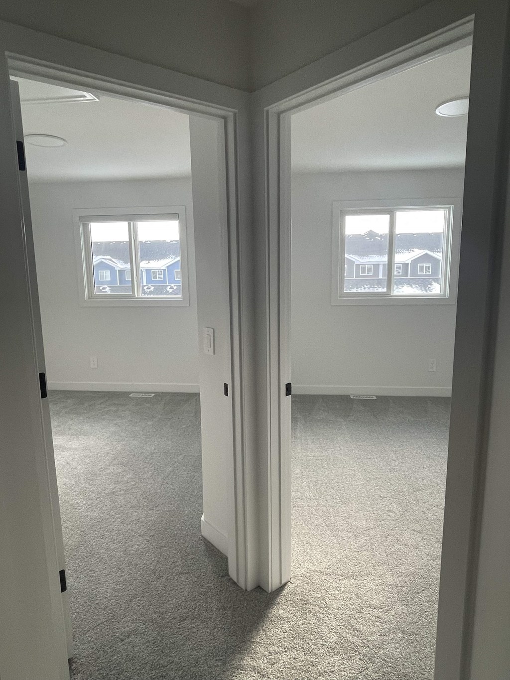 a bedroom with a view of the living room and bedroom door open
