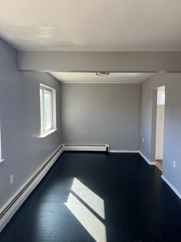 a empty room with a black floor and a window