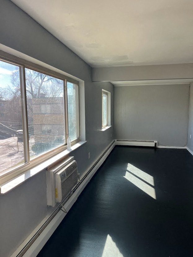 a empty room with a large window and a radiator