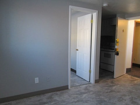 the living room door is open to the kitchen and the door to the dining room