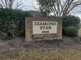 a sign for diamond star in front of a house